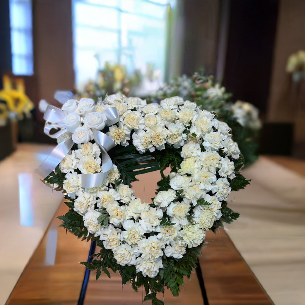 Open heart of cream carnations with roses