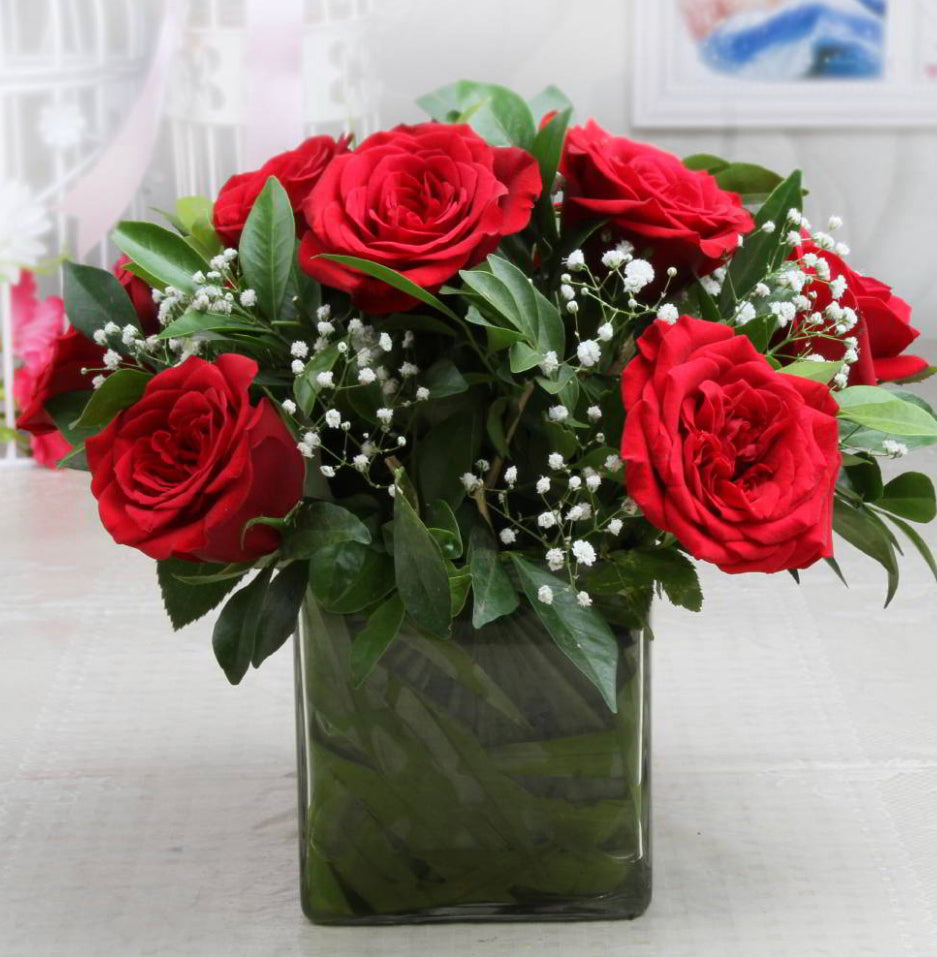 12 red roses in a glass vase